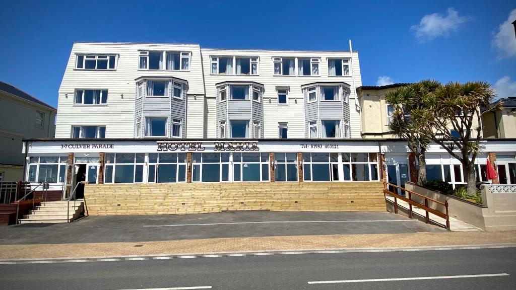 a large white building on the side of a street at Hotel Maria in Sandown