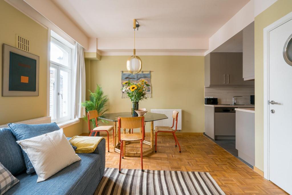 a living room with a blue couch and a table at Smartflats - Central Ghent in Ghent