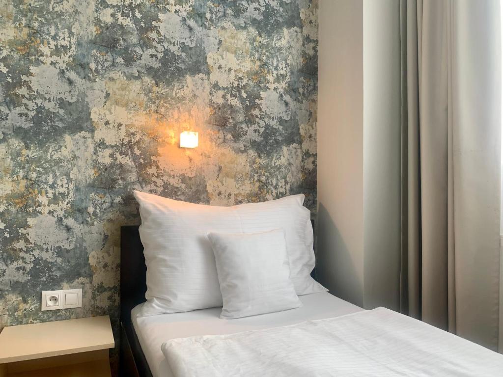 Postel nebo postele na pokoji v ubytování Hotel Abácie & Wellness
