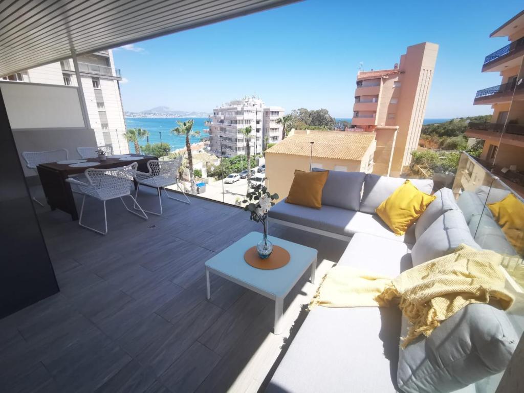 a living room with a couch and a table on a balcony at Superior Calpe Pearl Beach in Calpe
