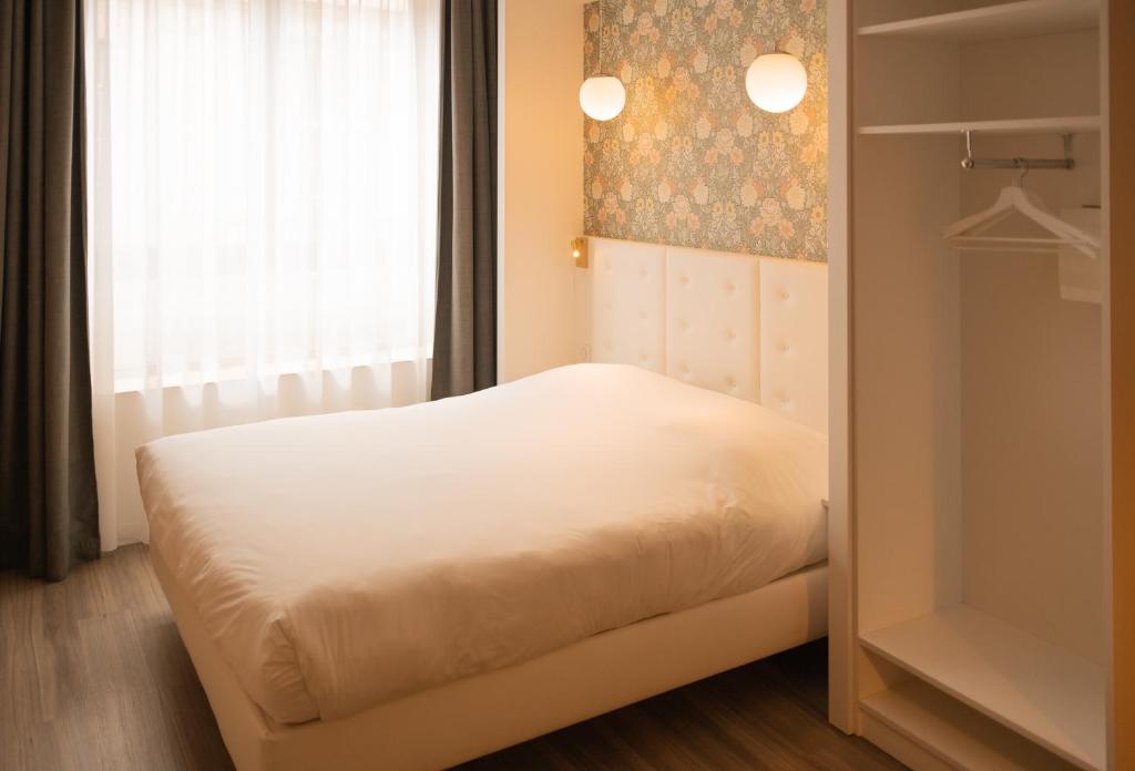 Postel nebo postele na pokoji v ubytování CALM Appart' & Hostel