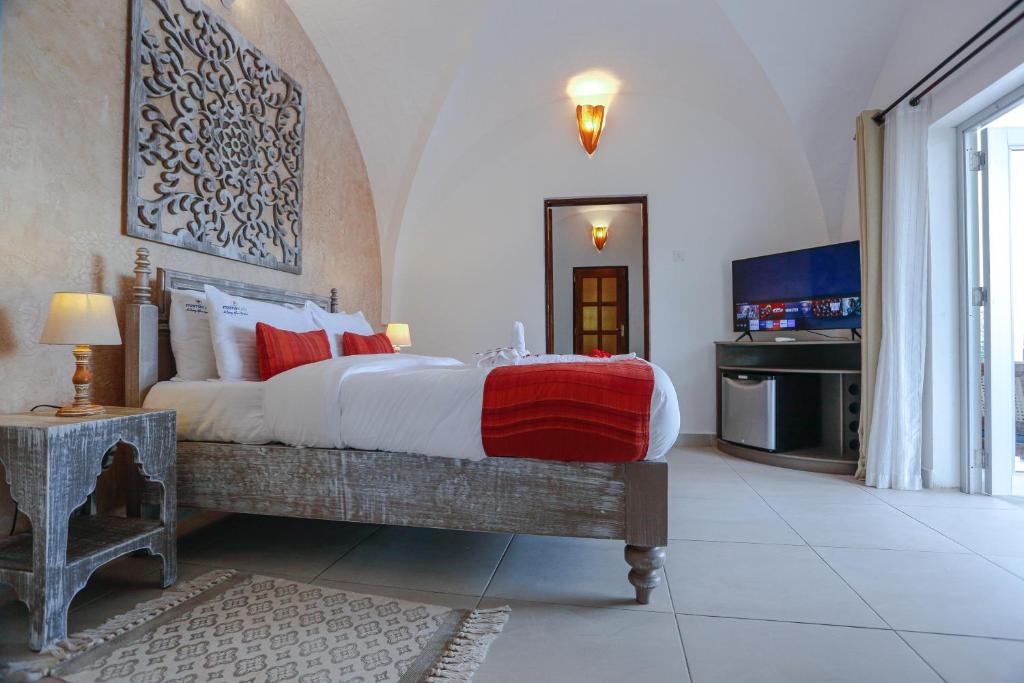 Postel nebo postele na pokoji v ubytování Mzima Beach Residences - Diani Beach