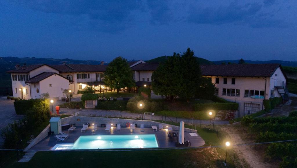 a house with a swimming pool at night at Locanda Del Pilone in Alba