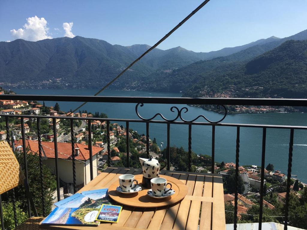 - un balcon avec une table et une vue sur l'eau dans l'établissement Casa Belvedere, à Moltrasio