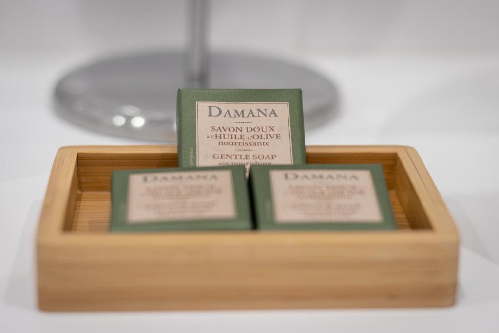 two books sitting on top of a wooden tray at Roots Hotel in Faro