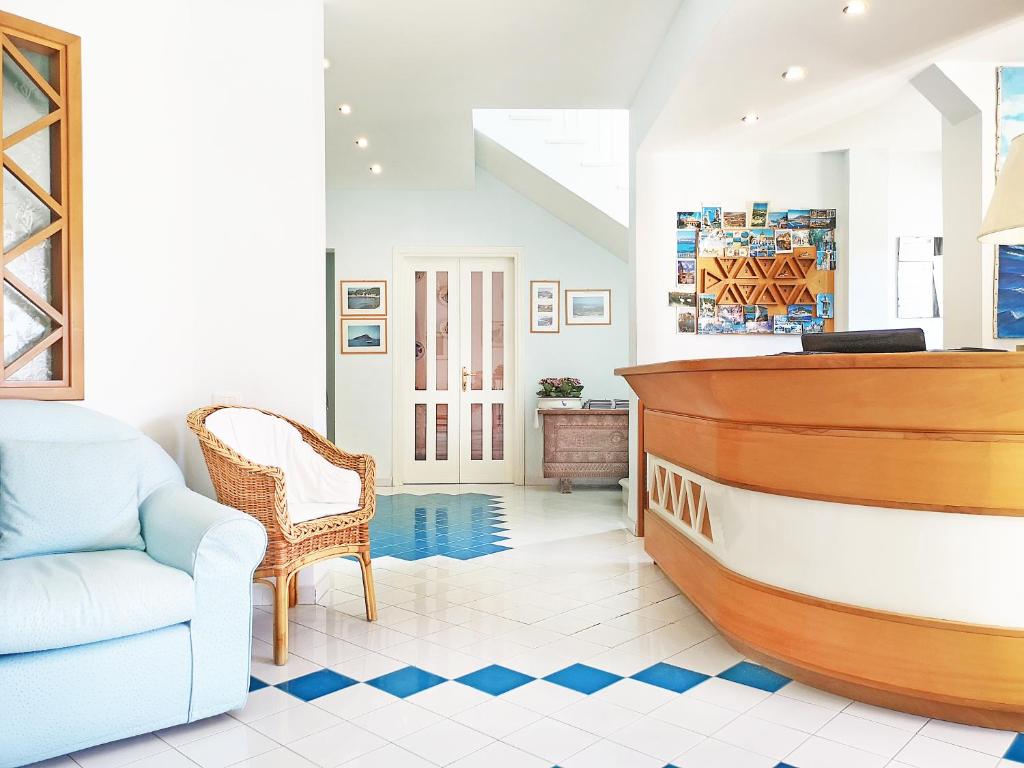 a living room with a boat and a chair at Hotel La Lampara in Golfo Aranci