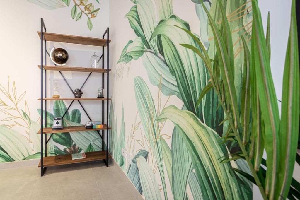 a room with a plant mural on the wall at Roots Hotel in Faro