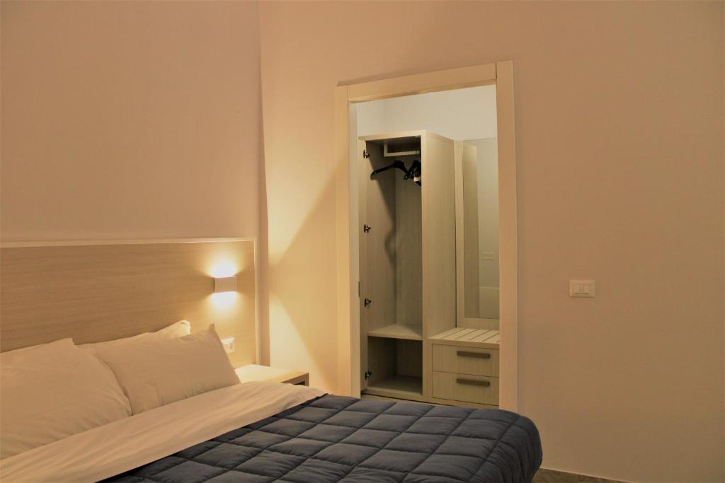 a bedroom with a bed and a large mirror at Zibibbo Beach Apartments - Trapani in Trapani