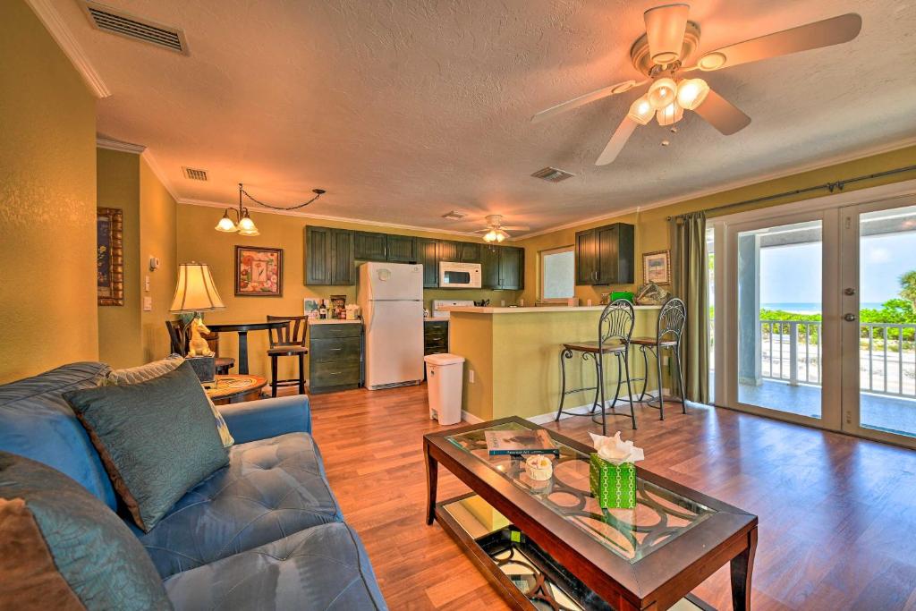 a living room with a couch and a table at Bright Coastal Condo Walk to Lido Key Beach! in Sarasota