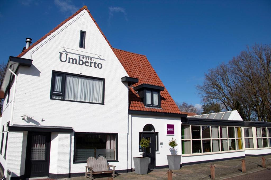 ein weißes Gebäude mit rotem Dach in der Unterkunft Hotel Umberto in Wijchen