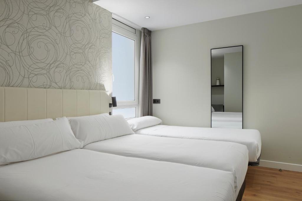 Postel nebo postele na pokoji v ubytování Hotel Arrizul Beach