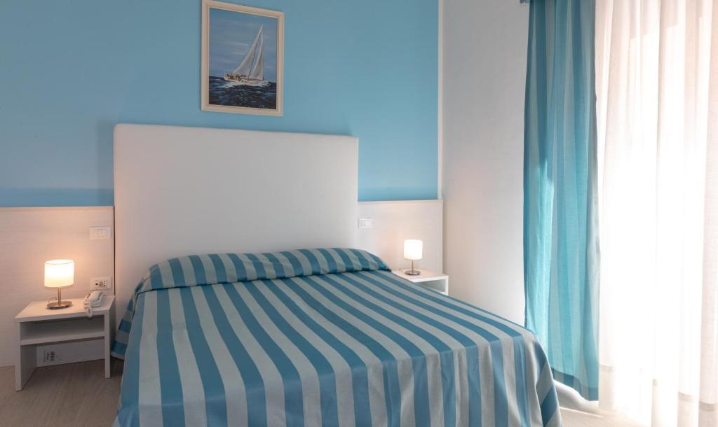 Postel nebo postele na pokoji v ubytování Hotel Paolina