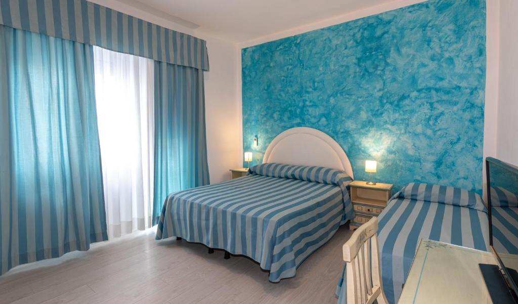 Postel nebo postele na pokoji v ubytování Hotel Paolina