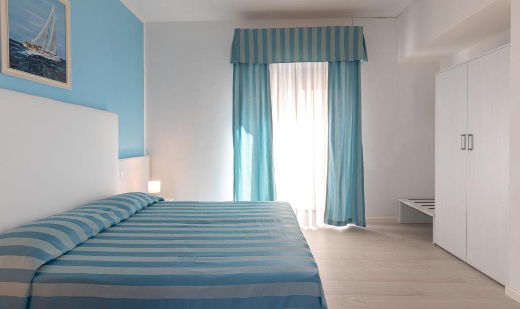 Postel nebo postele na pokoji v ubytování Hotel Paolina