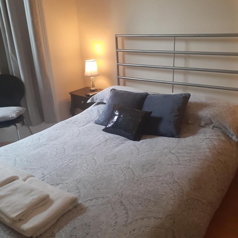 - une chambre avec un lit blanc et des serviettes dans l'établissement 2 Bodwen Villas, à Llangollen