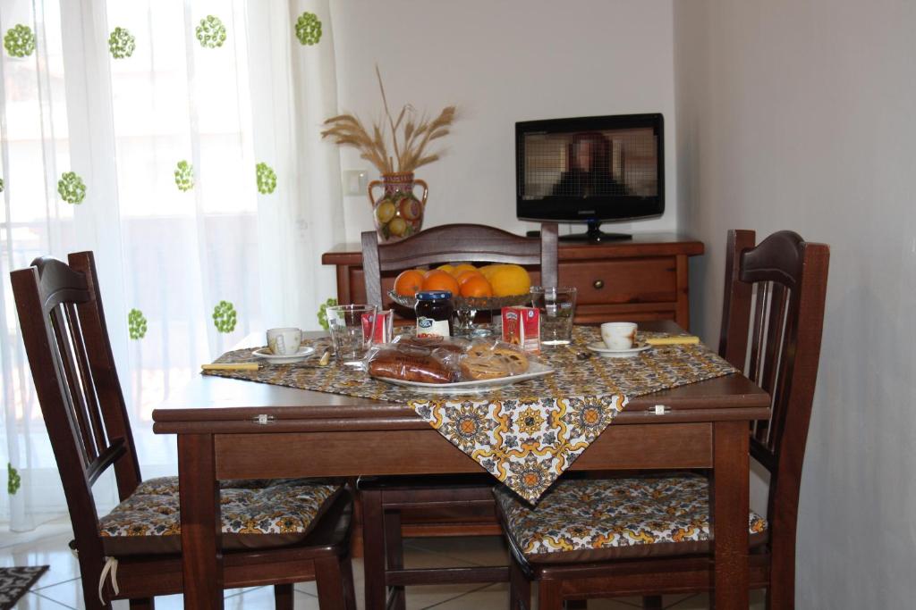 a dining room table with a plate of food on it at Da Lorenzo Apartment in Gaggi