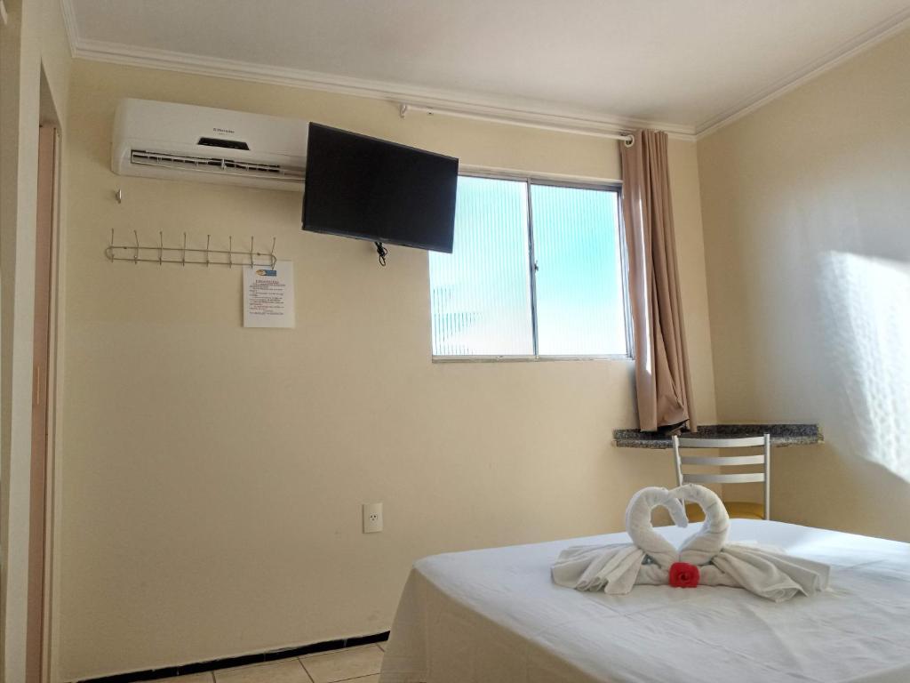 een kamer met een bed met een handdoek erop bij Pousada Aconchego in Juazeiro do Norte