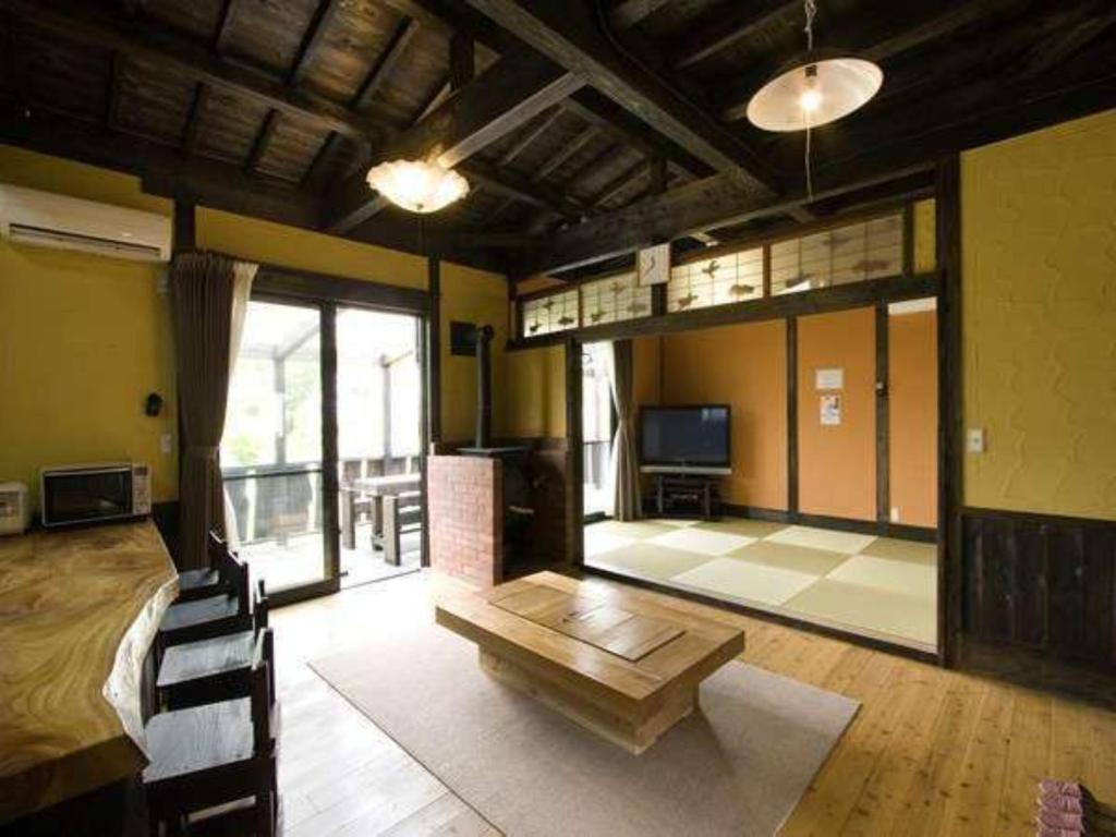 a large room with a bed and a table in it at Log house for 12 people - Vacation STAY 35074v in Minamioguni