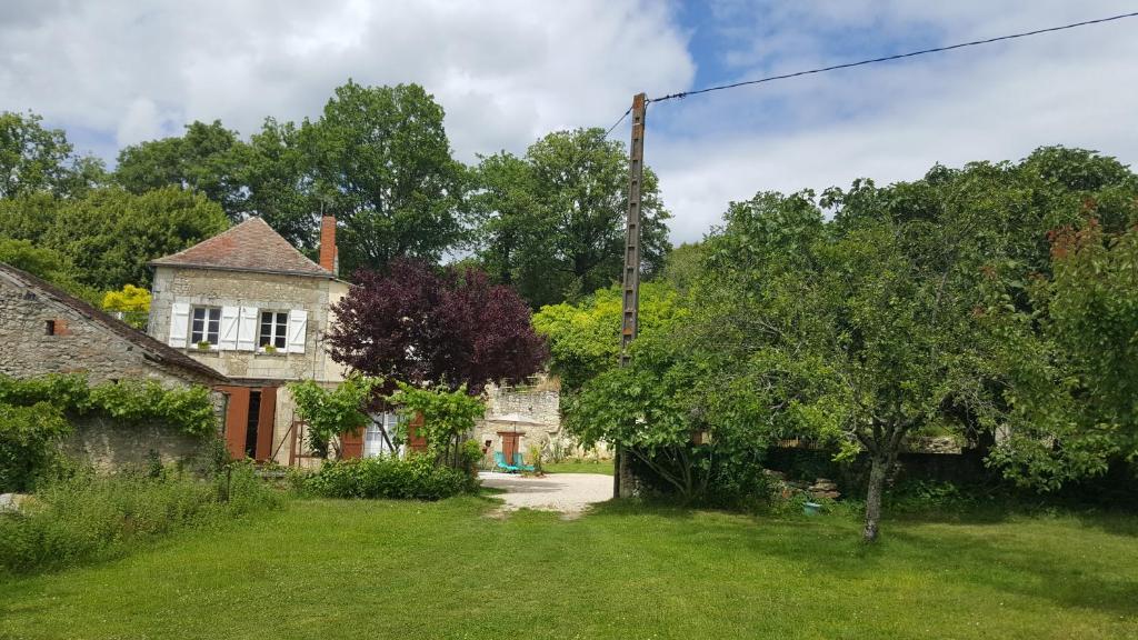 an old house in the middle of a yard at Gite de La Pivarderie in Sénillé