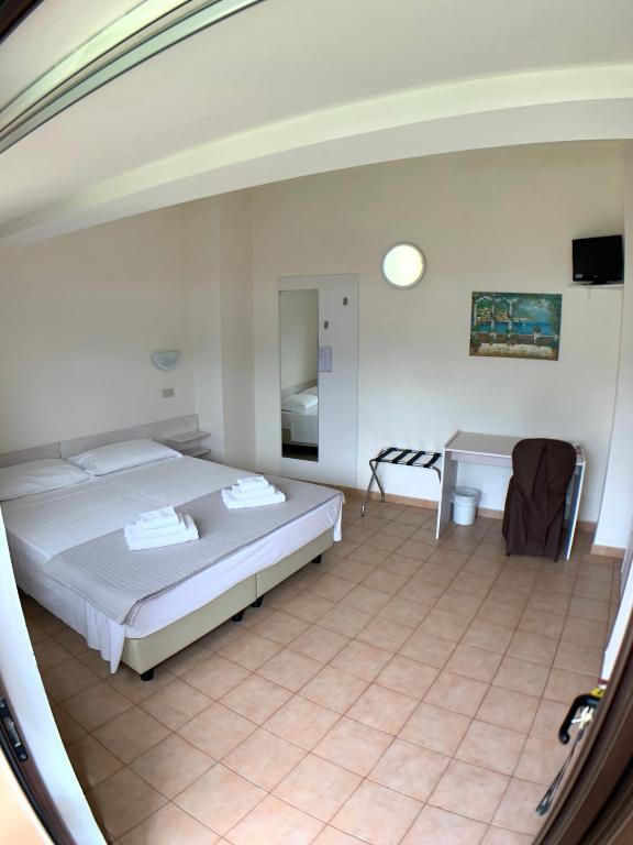 Postel nebo postele na pokoji v ubytování Hotel Sorriso