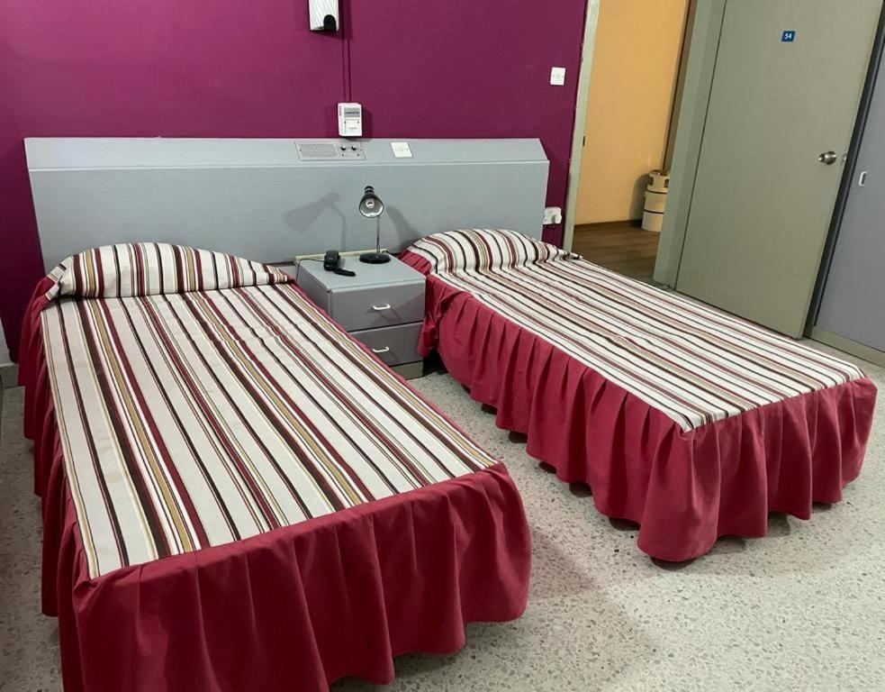 Postel nebo postele na pokoji v ubytování Roma Hotel