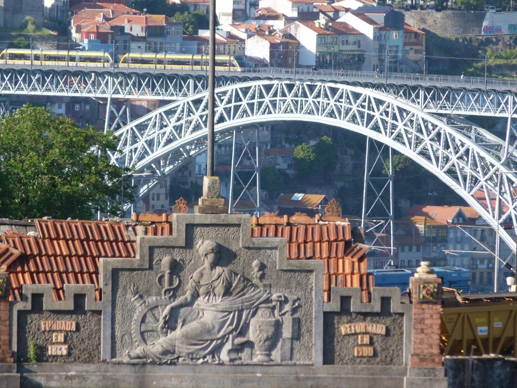 une statue d'un homme devant un pont dans l'établissement Cubicullum, à Vila Nova de Gaia