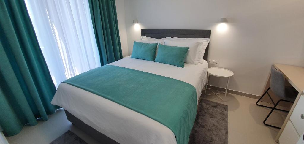 Posteľ alebo postele v izbe v ubytovaní Apartments Elite