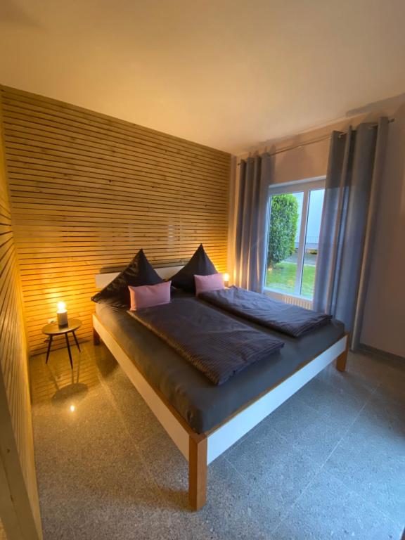 a bedroom with a large bed with a window at Apartment 1 Zimmer in Friesenheim