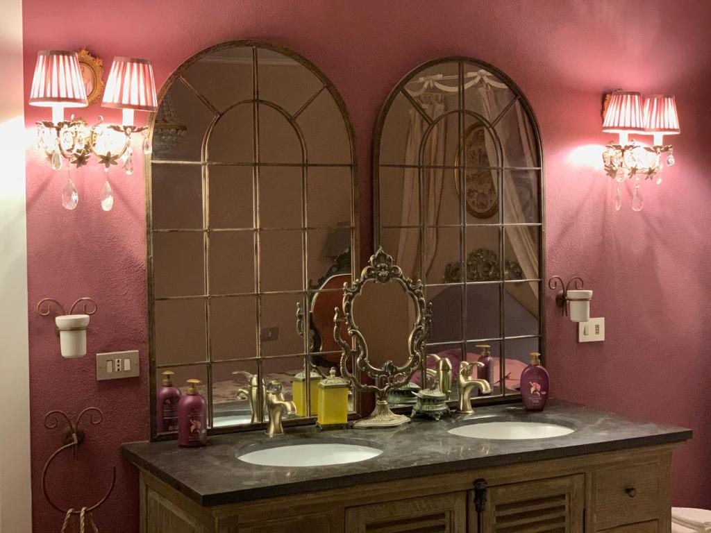 a bathroom with two sinks and a large mirror at Il Giardino Segreto Arona in Arona