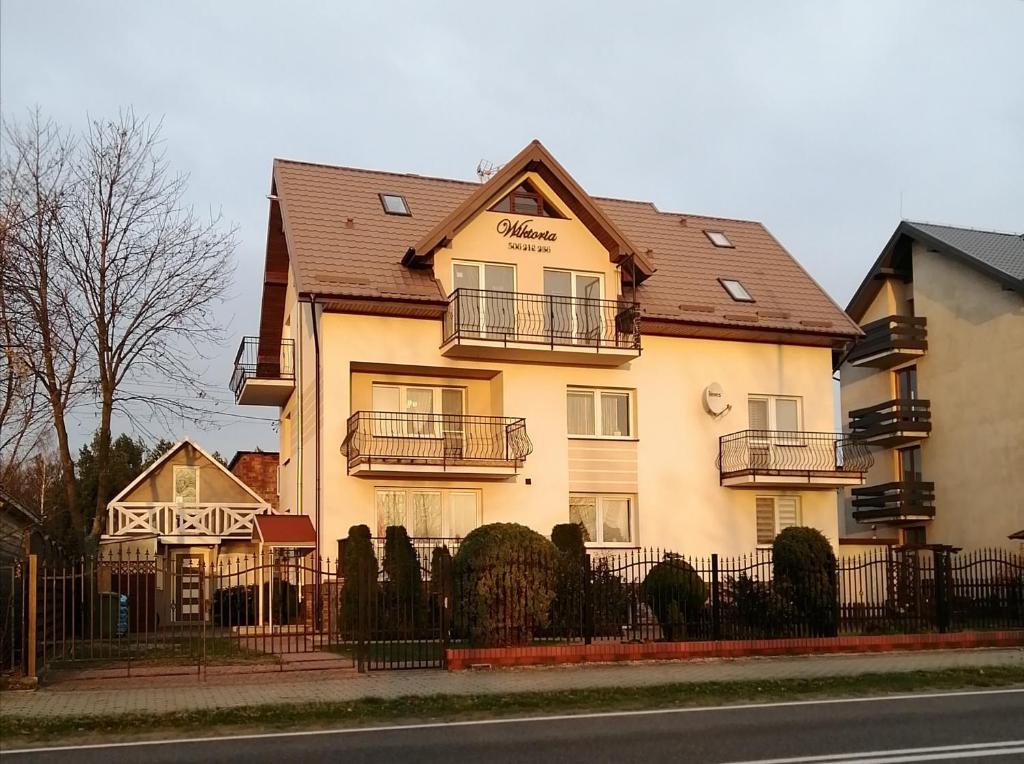 a large building with a fence in front of it at Apartamenty WIKTORIA morska18 in Kuźnica