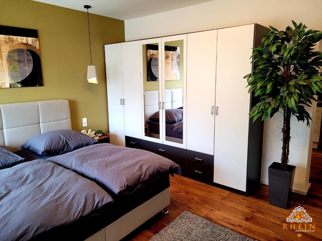 sypialnia z łóżkiem i doniczką w obiekcie Top Modernes Rhein Apartment Vallendar w mieście Vallendar