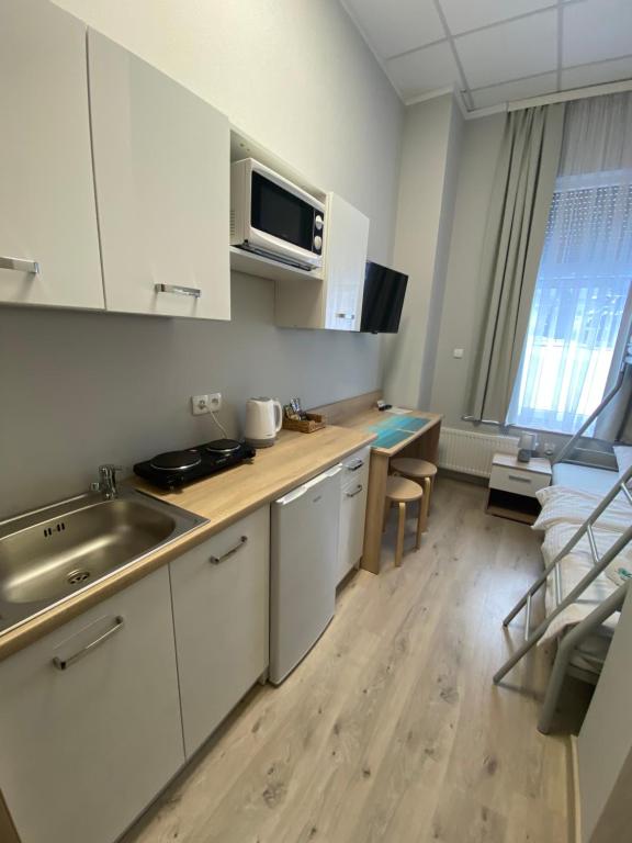 Kuchyňa alebo kuchynka v ubytovaní Apartamenty Olsztyn
