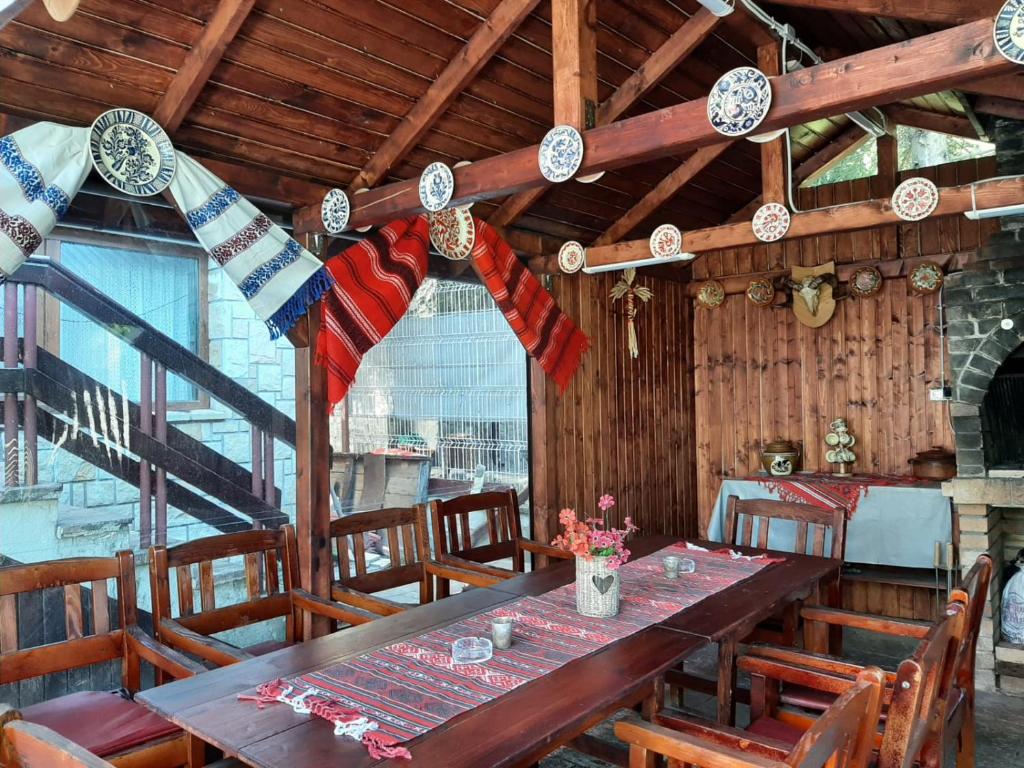 a wooden dining room with a table and chairs at Pensiunea Constanta in Predeal