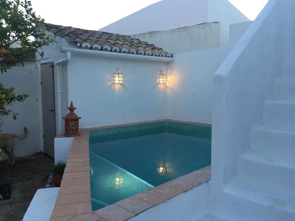 a swimming pool in the backyard of a house at Casa Largo do Poço Guesthouse in Alvor
