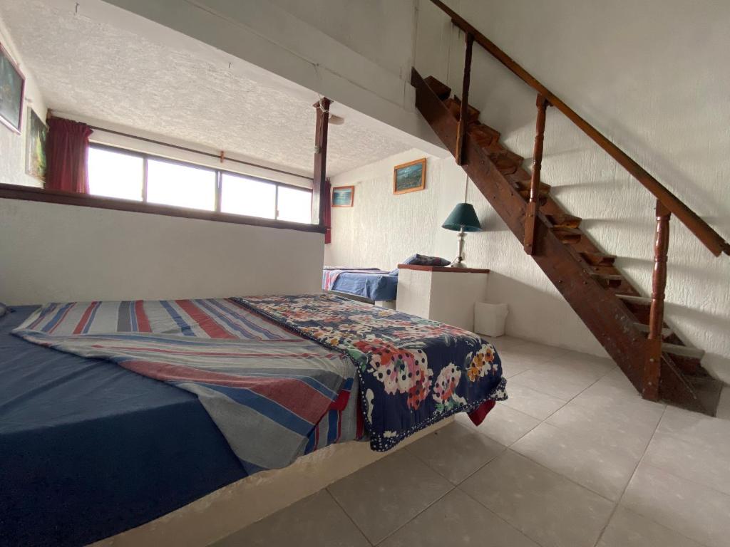 Postel nebo postele na pokoji v ubytování Hotel San Felipe de Jesus Yucatan