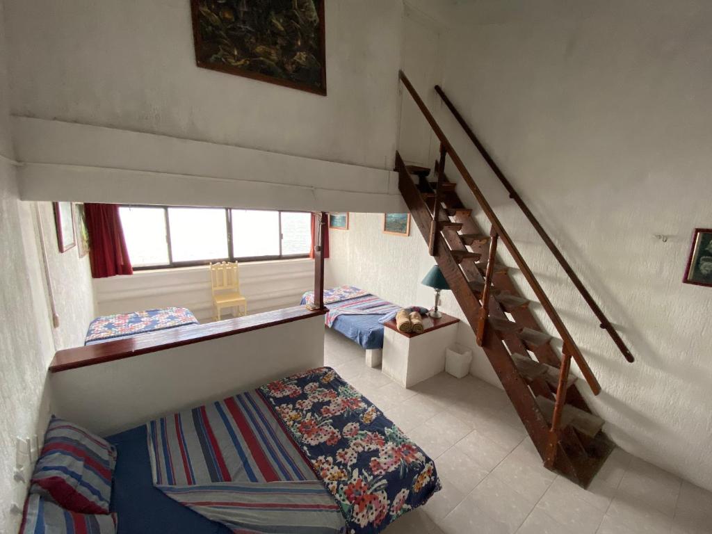 Postel nebo postele na pokoji v ubytování Hotel San Felipe de Jesus Yucatan