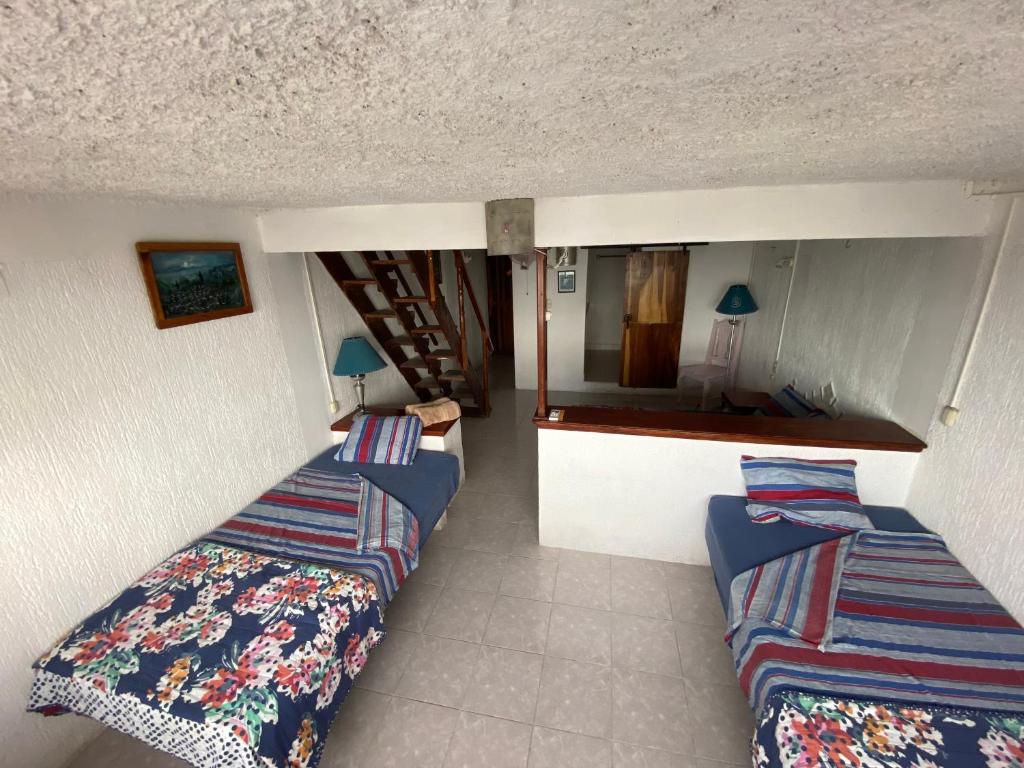 Postel nebo postele na pokoji v ubytování Hotel San Felipe de Jesus Yucatan