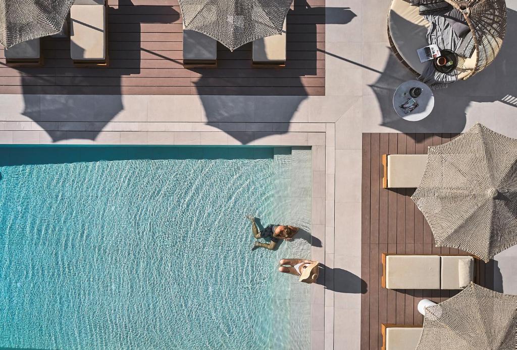 an overhead view of a person standing next to a swimming pool at Nival Boutique Hotel in Sifnos