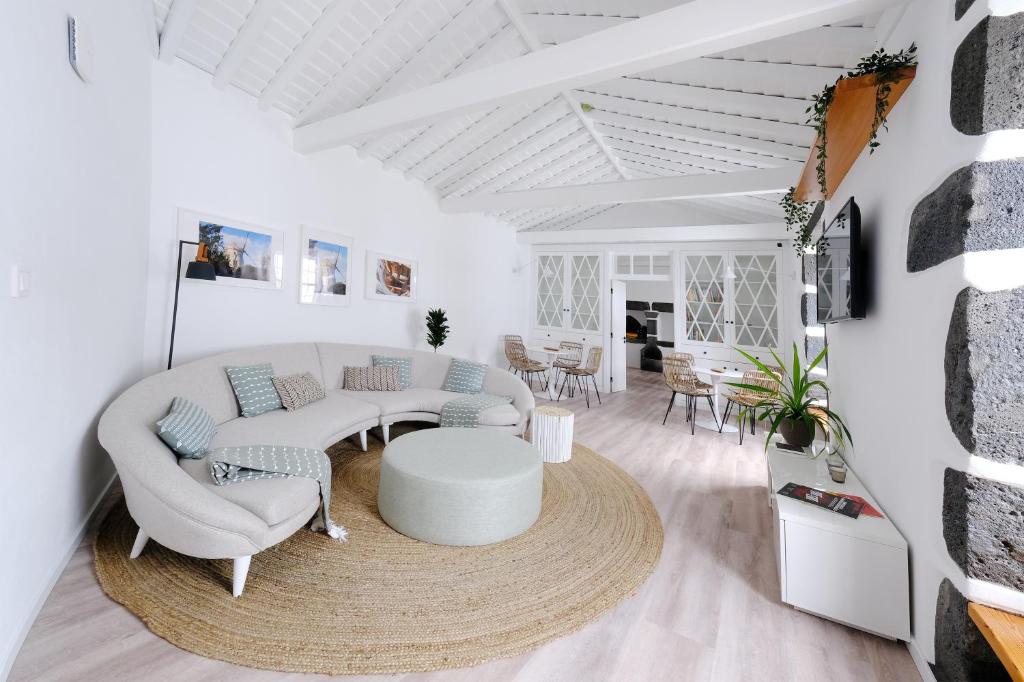 a living room with a couch and a table at Boa Nova Hostel in Santa Cruz da Graciosa