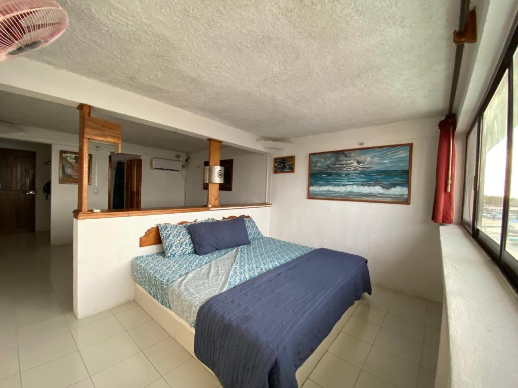 Postel nebo postele na pokoji v ubytování Hotel San Felipe de Jesus Yucatan