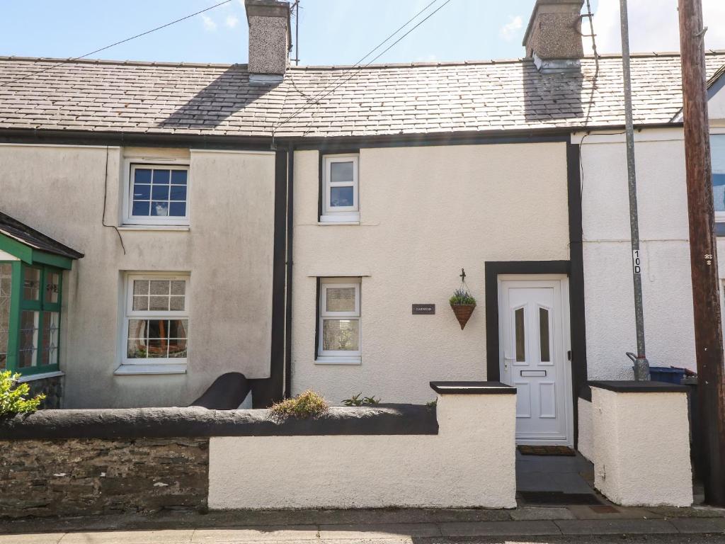 a white house with a white door at Garnedd in Holyhead