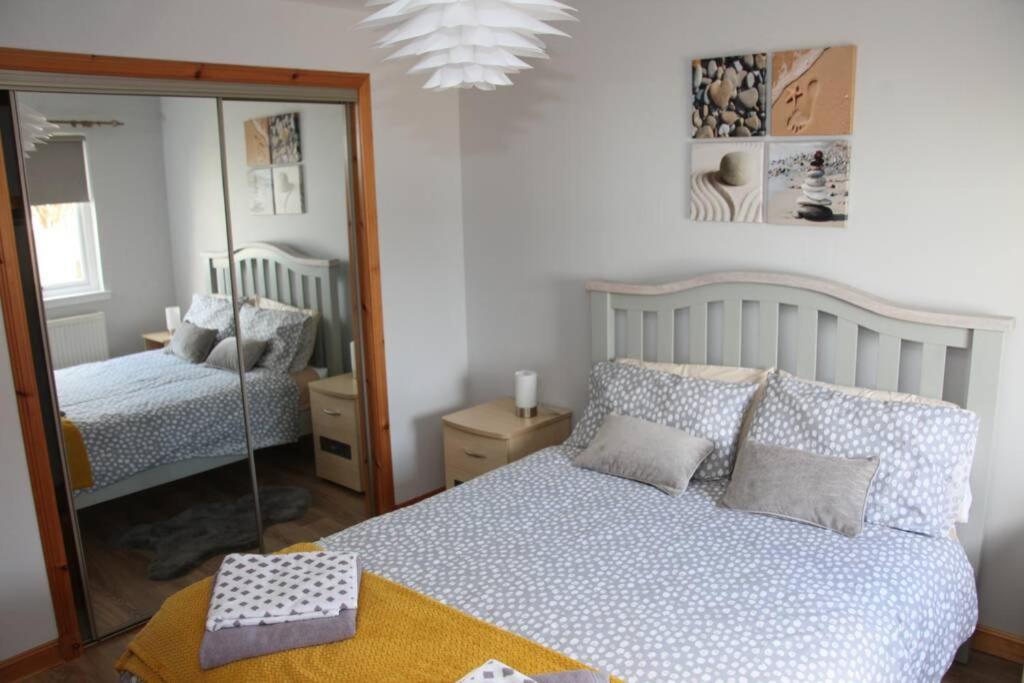 a bedroom with a bed and a mirror at BELL ROCK VIEW ARBROATH in Angus