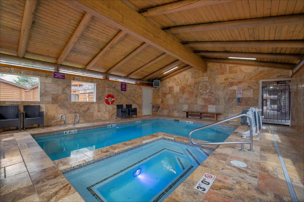 a swimming pool in a house with a wooden ceiling at Cowboy Village Resort in Jackson