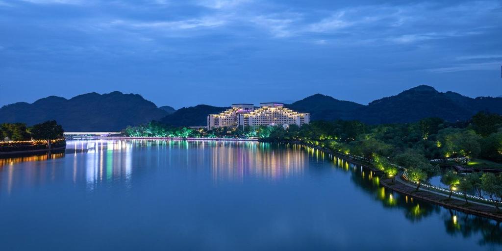 a view of a river at night with a city at Crowne Plaza Huangshan Yucheng, an IHG Hotel in Huangshan