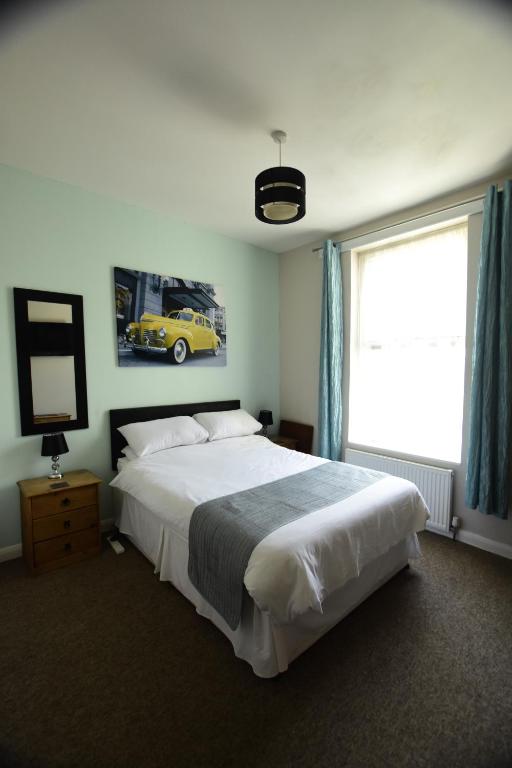Cama o camas de una habitación en Grosvenor Guest House