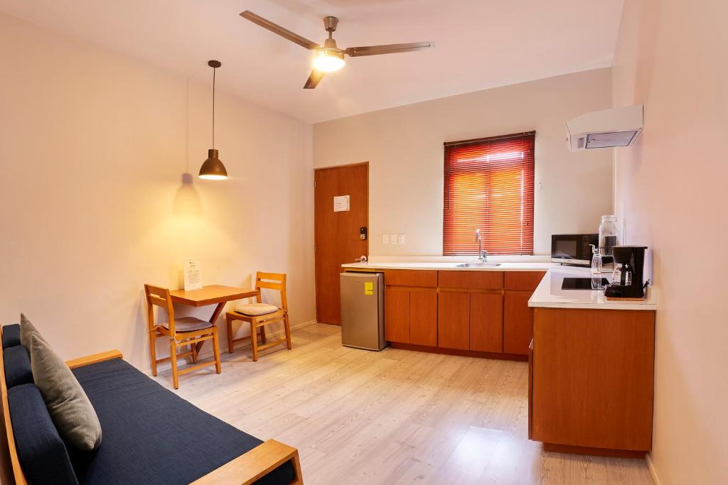 a kitchen and living room with a couch and a table at Casa Palo Verde in Cabo San Lucas