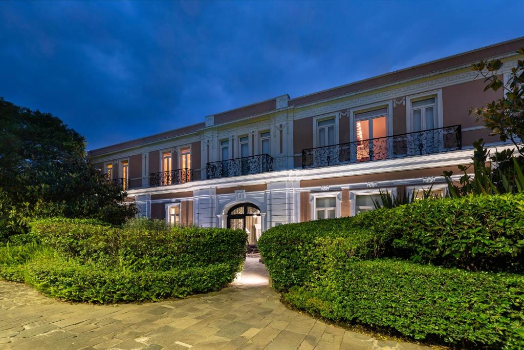 a large building with bushes in front of it at Hacienda Peña Pobre in Mexico City