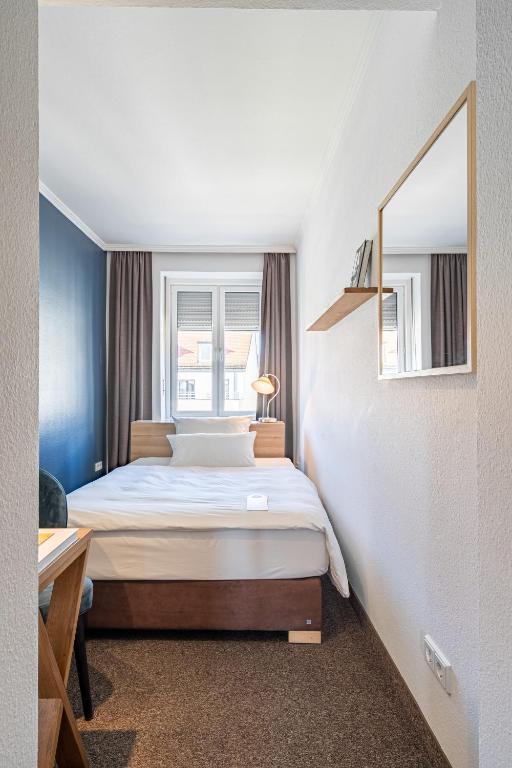 Postel nebo postele na pokoji v ubytování Hotel Stachus