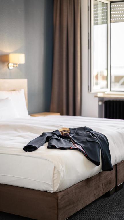 Postel nebo postele na pokoji v ubytování Hotel Stachus