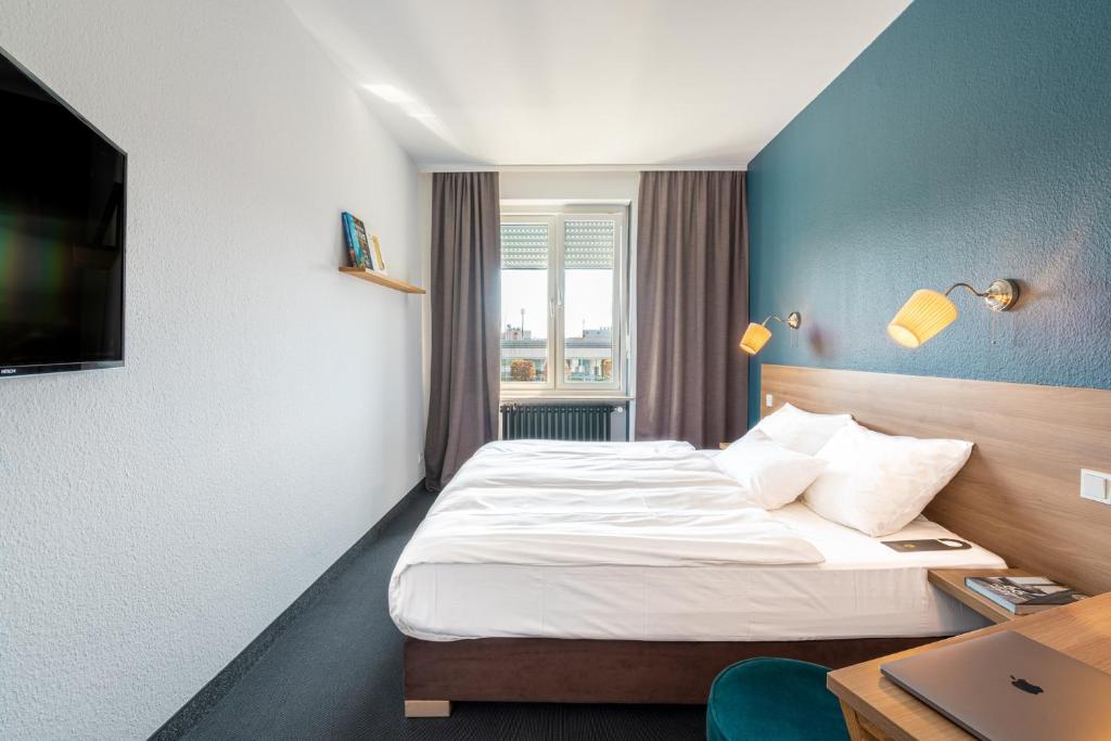 Postel nebo postele na pokoji v ubytování Hotel Stachus